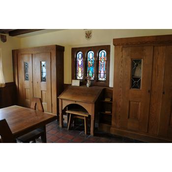 The Baden Powell Room contains a stained glass window featuring representations of Faith, Hope, and Charity.